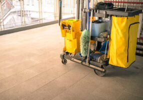 Cleaning tools cart in public walk way. Bucket and set of cleaning equipment. Concept of service, worker and equipment for cleaner and health.